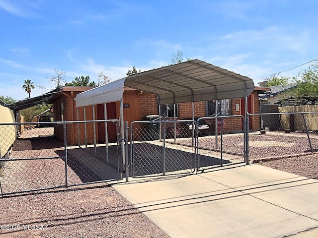 1443 W Hualpai Rd, Tucson, AZ 85745 - view of front of house featuring a gate, a carport, brick siding, and concrete driveway