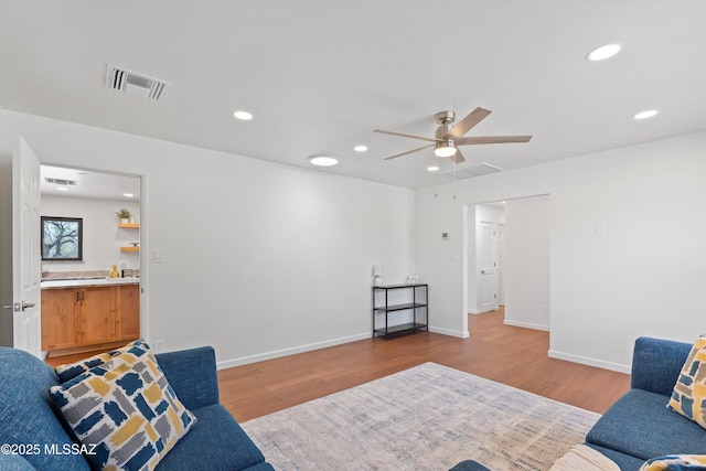 1241 W Cananea Cir, Tucson, AZ 85704 - living area with wood finished floors, a ceiling fan, recessed lighting, and baseboards