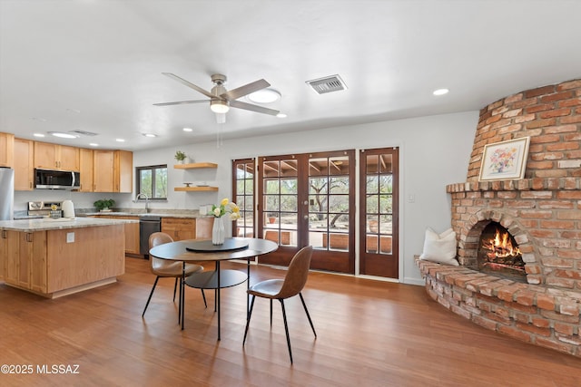 1241 W Cananea Cir, Tucson, AZ 85704 - dining space featuring a brick fireplace, light wood finished floors, ceiling fan, and recessed lighting