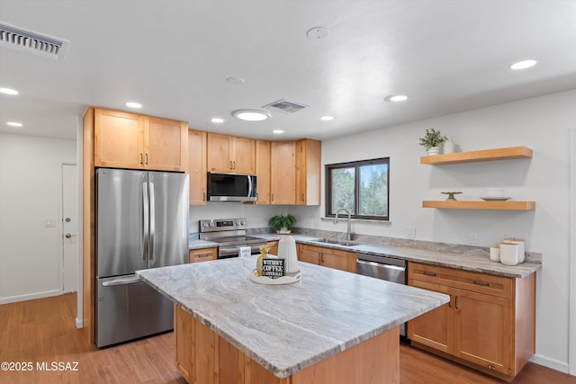 1241 W Cananea Cir, Tucson, AZ 85704 - kitchen featuring stainless steel appliances, a sink, light wood-type flooring, light stone counters, and recessed lighting