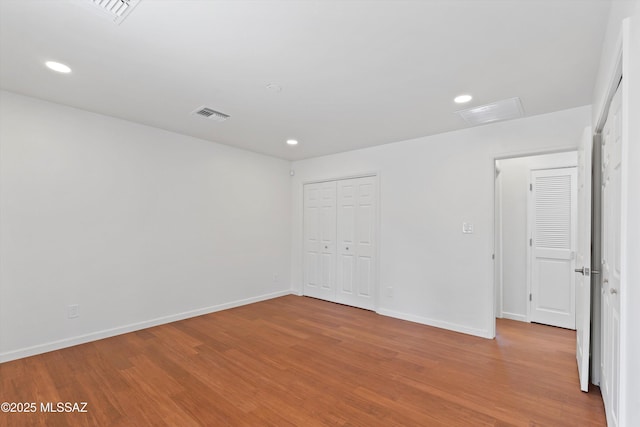 1241 W Cananea Cir, Tucson, AZ 85704 - unfurnished room featuring wood finished floors, baseboards, recessed lighting, and attic access