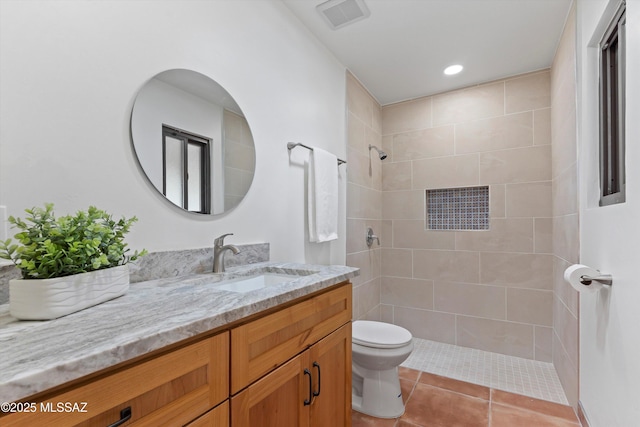 1241 W Cananea Cir, Tucson, AZ 85704 - bathroom with toilet, vanity, a tile shower, tile patterned flooring, and recessed lighting