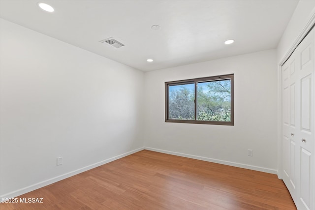 1241 W Cananea Cir, Tucson, AZ 85704 - unfurnished bedroom featuring light wood-style flooring, a closet, baseboards, and recessed lighting
