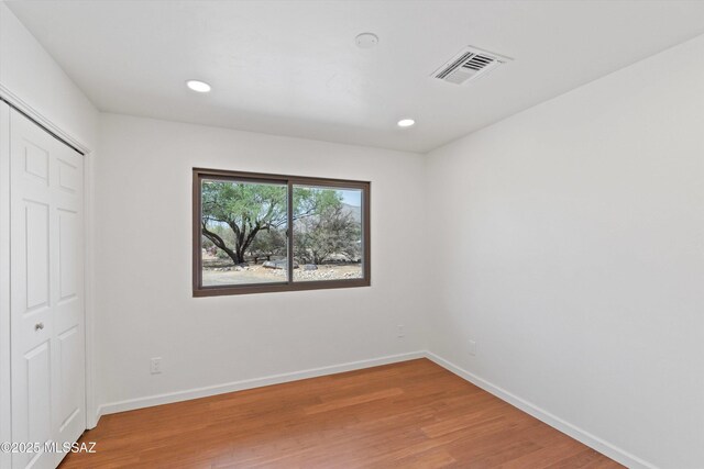 1241 W Cananea Cir, Tucson, AZ 85704 - unfurnished bedroom featuring light wood-type flooring, baseboards, recessed lighting, and a closet
