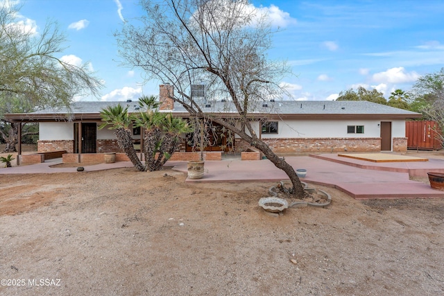 1241 W Cananea Cir, Tucson, AZ 85704 - back of house featuring brick siding, a patio, and a chimney