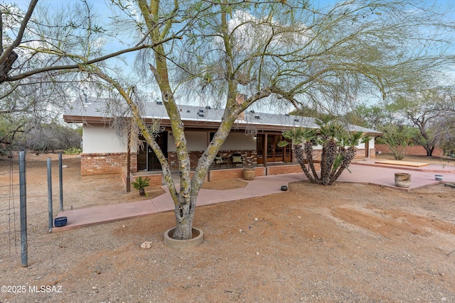 1241 W Cananea Cir, Tucson, AZ 85704 - view of front facade with brick siding and a patio