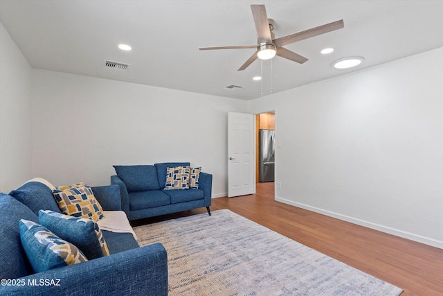 1241 W Cananea Cir, Tucson, AZ 85704 - living area featuring wood finished floors, a ceiling fan, baseboards, and recessed lighting