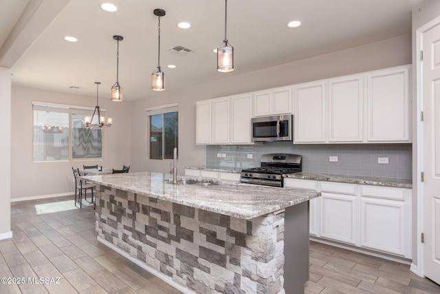 8040 N Desert Gum Dr, Tucson, AZ 85741 - kitchen featuring stainless steel appliances, a sink, tasteful backsplash, a chandelier, and wood finish floors