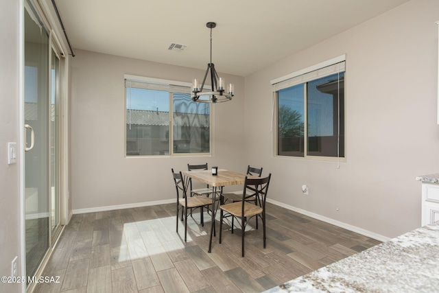 8040 N Desert Gum Dr, Tucson, AZ 85741 - dining space featuring wood finished floors, a chandelier, and baseboards