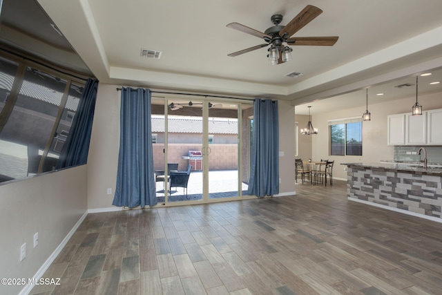 8040 N Desert Gum Dr, Tucson, AZ 85741 - unfurnished living room with a ceiling fan, a sink, wood finished floors, baseboards, and recessed lighting