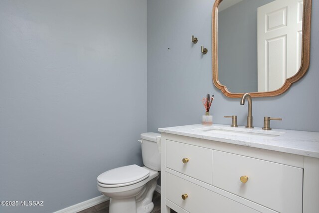 8040 N Desert Gum Dr, Tucson, AZ 85741 - bathroom featuring toilet, vanity, and baseboards
