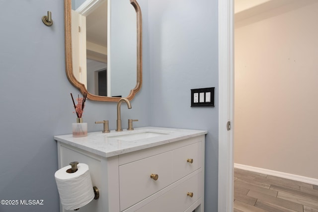 8040 N Desert Gum Dr, Tucson, AZ 85741 - bathroom with wood finished floors, vanity, and baseboards