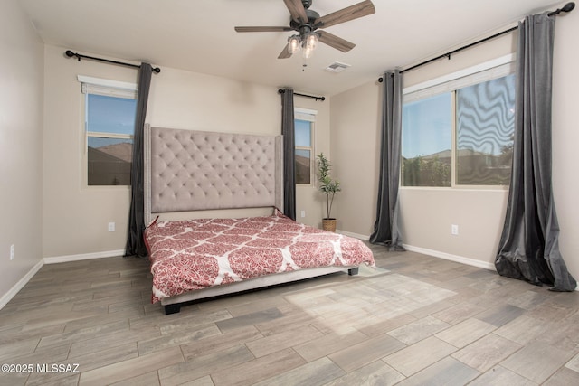 8040 N Desert Gum Dr, Tucson, AZ 85741 - bedroom with wood finished floors, baseboards, and ceiling fan