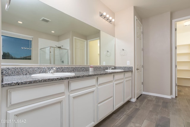 8040 N Desert Gum Dr, Tucson, AZ 85741 - full bath with a shower stall, double vanity, wood finished floors, recessed lighting, and a closet