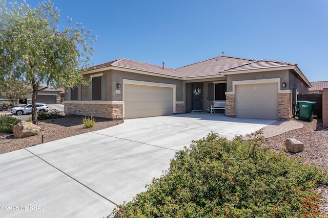 8040 N Desert Gum Dr, Tucson, AZ 85741 - view of front of house featuring a garage, driveway, stone siding, a tiled roof, and stucco siding