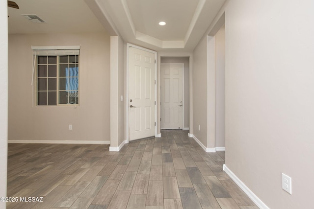 8040 N Desert Gum Dr, Tucson, AZ 85741 - corridor featuring wood finished floors, baseboards, a tray ceiling, and recessed lighting