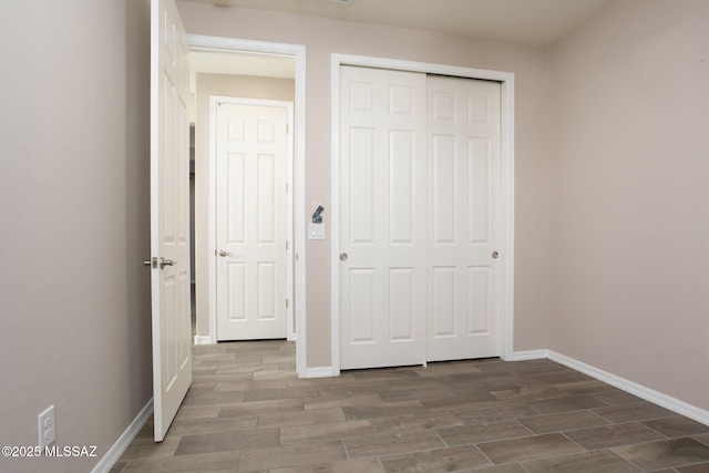 8040 N Desert Gum Dr, Tucson, AZ 85741 - unfurnished bedroom with wood finished floors, baseboards, and a closet