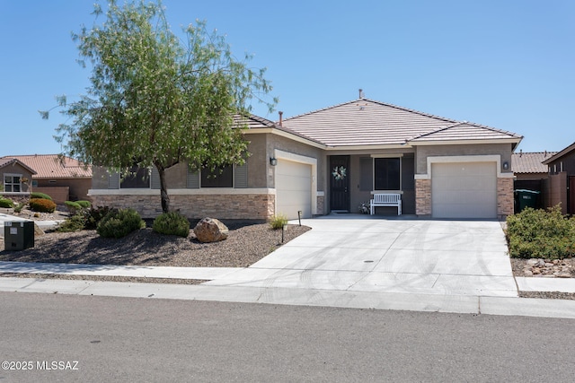 8040 N Desert Gum Dr, Tucson, AZ 85741 - view of front of property featuring an attached garage, stone siding, a tile roof, driveway, and stucco siding