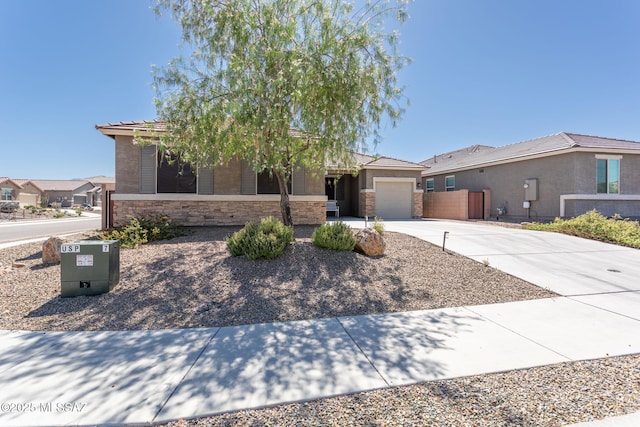 8040 N Desert Gum Dr, Tucson, AZ 85741 - view of front of property featuring concrete driveway, an attached garage, stone siding, a tile roof, and stucco siding
