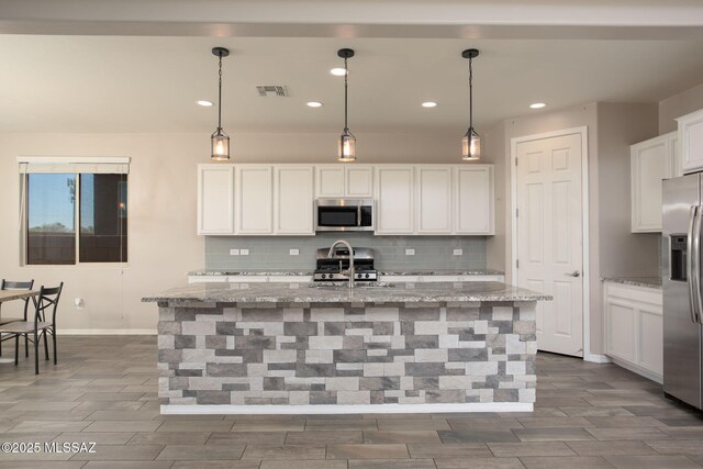 8040 N Desert Gum Dr, Tucson, AZ 85741 - kitchen with stainless steel appliances, backsplash, white cabinets, recessed lighting, and light stone countertops