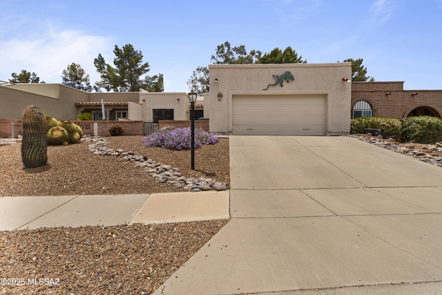 140 E Paseo De Golf, Green Valley, AZ 85614 - pueblo-style house featuring concrete driveway, stucco siding, and an attached garage