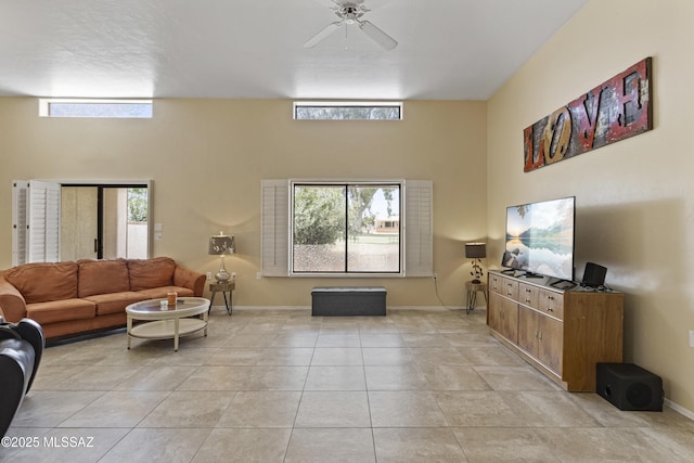 140 E Paseo De Golf, Green Valley, AZ 85614 - living area with ceiling fan, baseboards, light tile patterned floors, and a towering ceiling