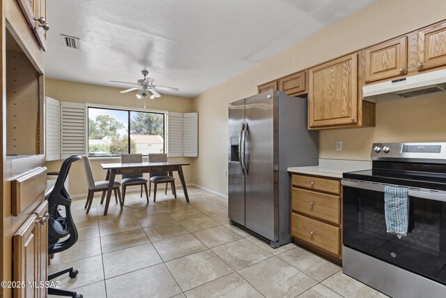 140 E Paseo De Golf, Green Valley, AZ 85614 - kitchen with stainless steel appliances, under cabinet range hood, ceiling fan, light countertops, and baseboards
