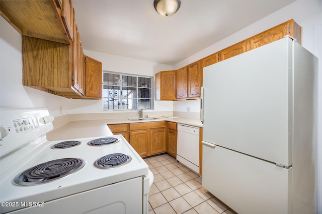 5449 E Rosewood St, Tucson, AZ 85711 - kitchen featuring white appliances, a sink, light countertops, light tile patterned floors, and brown cabinets