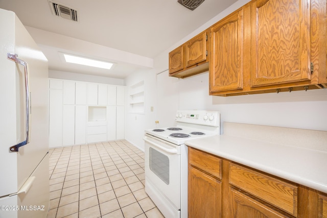 5449 E Rosewood St, Tucson, AZ 85711 - kitchen featuring white appliances, light tile patterned floors, light countertops, and brown cabinets