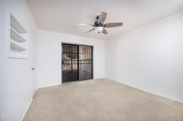 5449 E Rosewood St, Tucson, AZ 85711 - empty room with a ceiling fan, light carpet, and baseboards