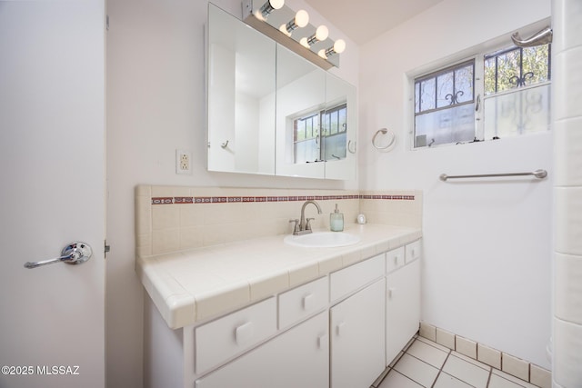 5449 E Rosewood St, Tucson, AZ 85711 - bathroom with vanity, tasteful backsplash, and tile patterned flooring