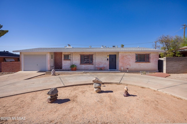 5449 E Rosewood St, Tucson, AZ 85711 - single story home featuring brick siding, driveway, and a garage