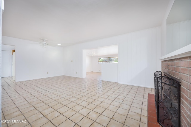 5449 E Rosewood St, Tucson, AZ 85711 - unfurnished living room featuring a fireplace, ceiling fan, and light tile patterned flooring