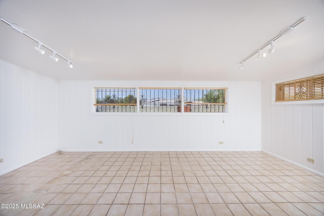5449 E Rosewood St, Tucson, AZ 85711 - empty room featuring track lighting and baseboards