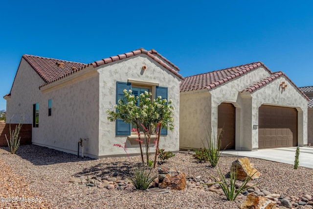 1936 N Star Vw Ln, Green Valley, AZ 85614 - mediterranean / spanish house featuring an attached garage, stucco siding, driveway, and a tile roof