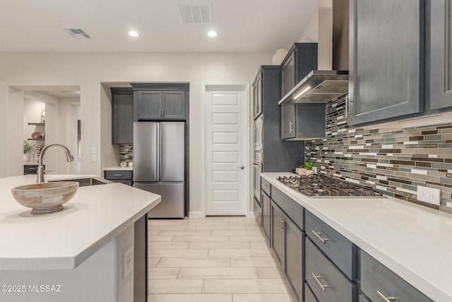 1936 N Star Vw Ln, Green Valley, AZ 85614 - kitchen with stainless steel appliances, wall chimney exhaust hood, a sink, backsplash, and light countertops
