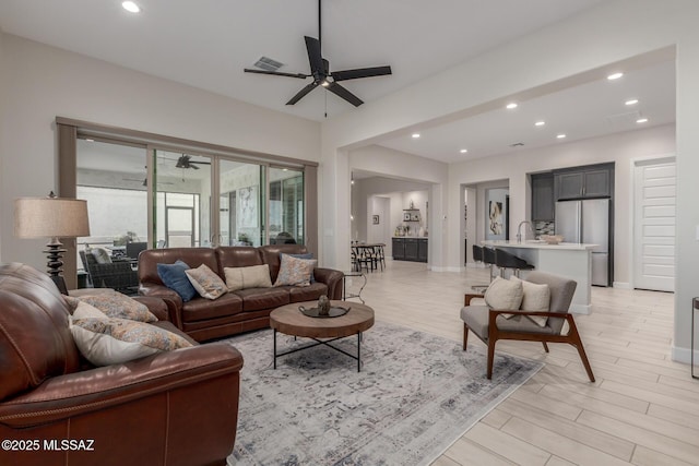 1936 N Star Vw Ln, Green Valley, AZ 85614 - living room featuring a ceiling fan, recessed lighting, light wood-style flooring, and baseboards