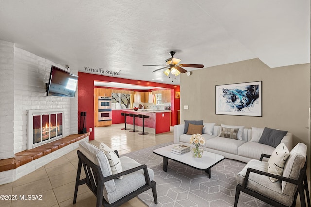 3600 N Hash Knife Cir, Tucson, AZ 85749 - living room featuring a ceiling fan, light tile patterned floors, and a brick fireplace