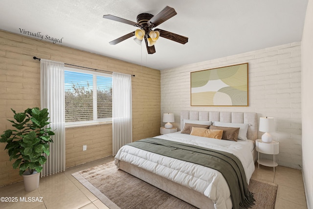 3600 N Hash Knife Cir, Tucson, AZ 85749 - bedroom featuring light tile patterned floors, brick wall, and a ceiling fan