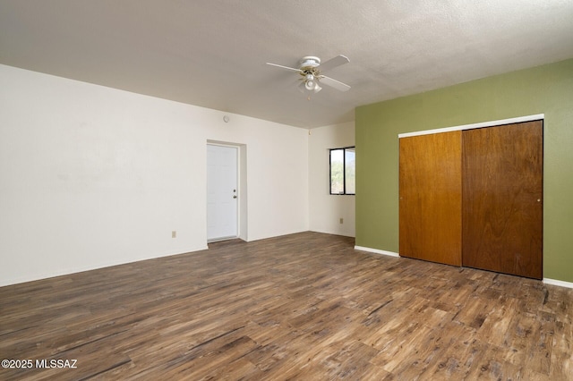 3600 N Hash Knife Cir, Tucson, AZ 85749 - unfurnished bedroom featuring wood finished floors, a closet, and a ceiling fan
