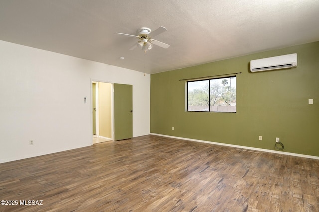 3600 N Hash Knife Cir, Tucson, AZ 85749 - empty room with a wall mounted AC, a ceiling fan, wood finished floors, and baseboards