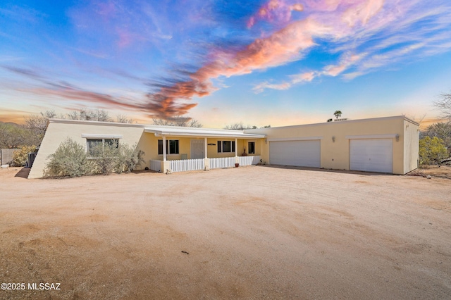 3600 N Hash Knife Cir, Tucson, AZ 85749 - view of front of property with covered porch, driveway, stucco siding, and a garage
