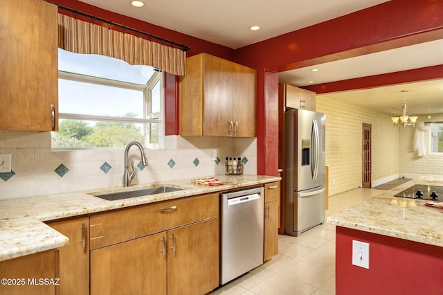 3600 N Hash Knife Cir, Tucson, AZ 85749 - kitchen featuring appliances with stainless steel finishes, a sink, tasteful backsplash, light tile patterned flooring, and light stone countertops