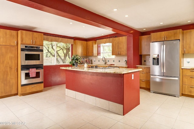 3600 N Hash Knife Cir, Tucson, AZ 85749 - kitchen featuring appliances with stainless steel finishes, brown cabinetry, and recessed lighting
