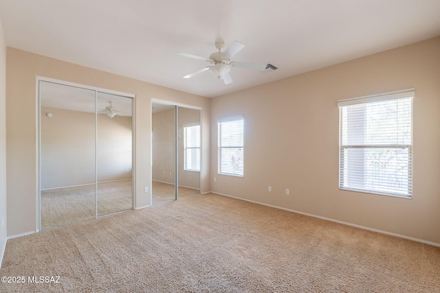 15815 S Via Cayetano, Sahuarita, AZ 85629 - unfurnished bedroom with two closets, carpet, baseboards, and a ceiling fan