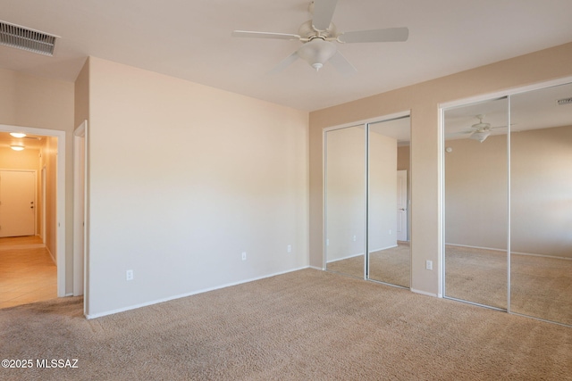 15815 S Via Cayetano, Sahuarita, AZ 85629 - unfurnished bedroom featuring multiple closets, carpet, baseboards, and a ceiling fan