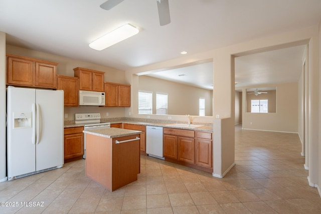 15815 S Via Cayetano, Sahuarita, AZ 85629 - kitchen featuring white appliances, a ceiling fan, a sink, a center island, and light tile patterned floors