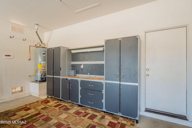 15815 S Via Cayetano, Sahuarita, AZ 85629 - kitchen with gas water heater and gray cabinets