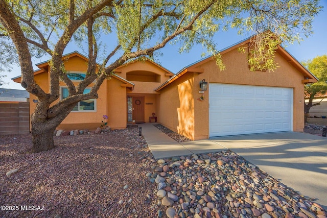 2804 W Camino Ebano, Tucson, AZ 85742 - view of front of home featuring stucco siding, driveway, and a garage
