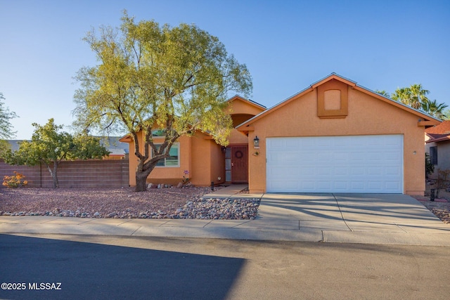 2804 W Camino Ebano, Tucson, AZ 85742 - view of front of home with stucco siding, driveway, fence, and a garage